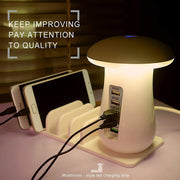 Mushroom-style LED charging strip with multiple devices plugged in on a table.